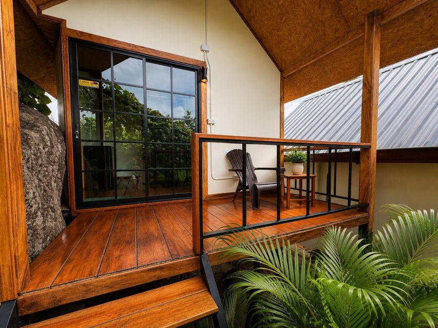Wooden porch with railing and garden view